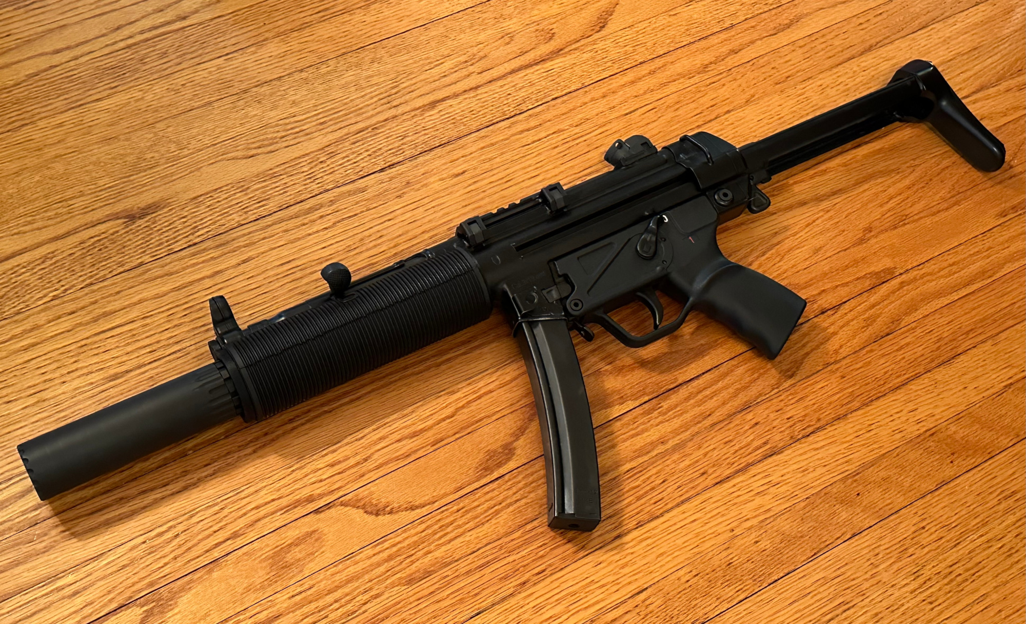 A picture of a fake MP5SD made using a printed adapter, a rubber shroud, and a YHM R9 viewed from the left side.