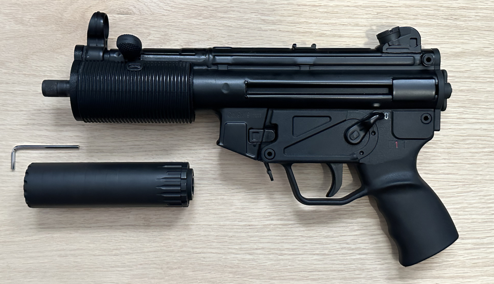 A picture of an MP5K wearing both the BL-SD adapter, and the Broad River Tactical rubber SD shroud. The YHM R9 appears below.