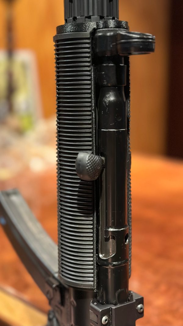 A closeup picture of a fake MP5SD made using a printed adapter, a rubber shroud, and a YHM R9.