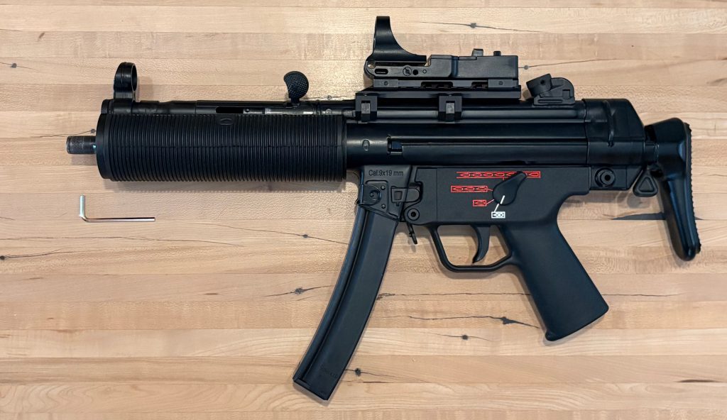 A picture of an MP5 wearing both the BL-SD adapter, and the German rubber shroud. 